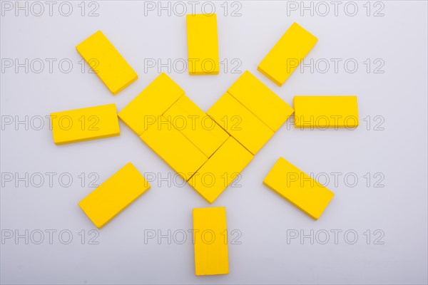 Colorful domino pices are forming a Sun shape