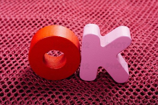 The word OK written with colorful letter blocks