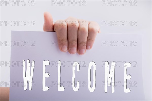 Hand holding welcome word on a white background