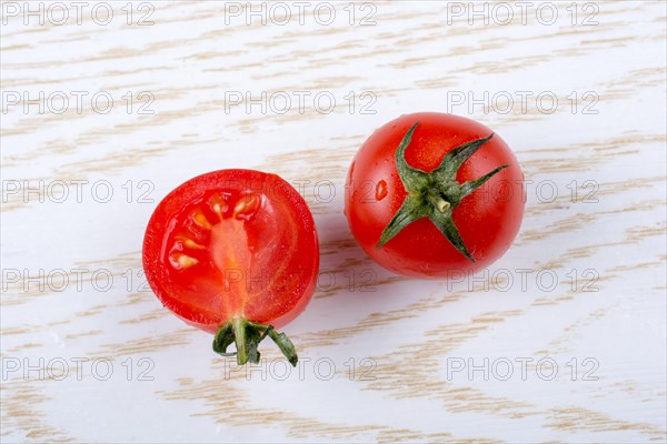 Red ripe tasty fresh cherry tomatos cut in halves