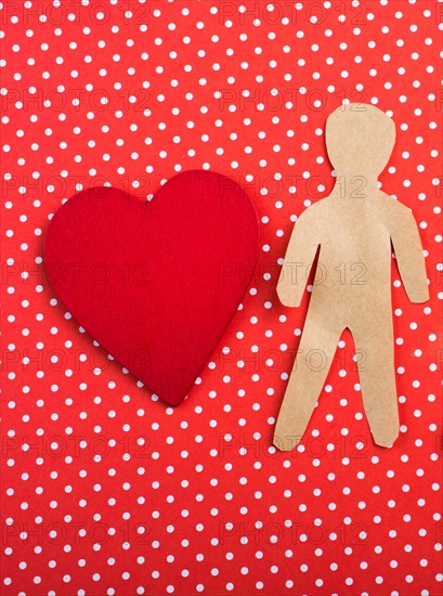 Heart and man and child shape cut out of paper