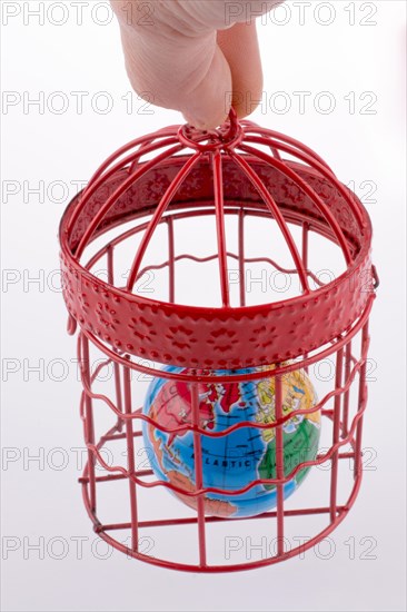 Small globe trapped in a red birdcage