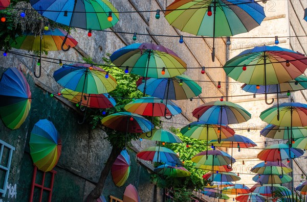 Rows Umbrellas floating above the street protecting from Sunlight