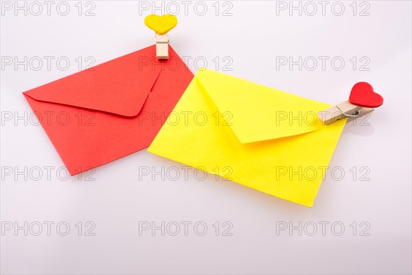 Red and yellow envelopes clipped with hearts