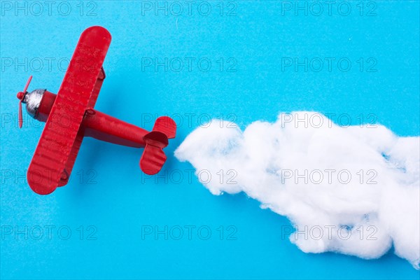 Retro styled little red model airplane in sky