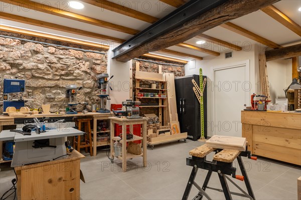 Interior space of a screen printing studio with no people and different tools and furniture to work