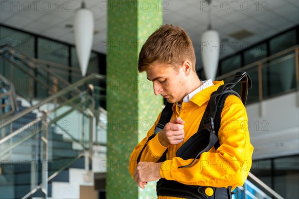 An employee putting on an exoskeleton from a futuristic high-tech warehouse