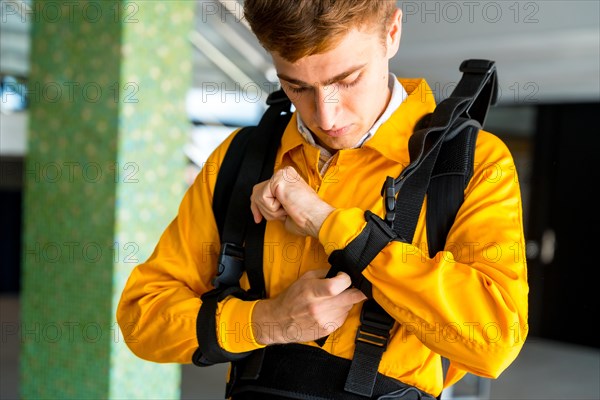 An employee putting on an exoskeleton from a futuristic high-tech warehouse