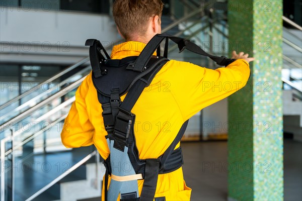 Employee with an exoskeleton from a futuristic high-tech warehouse