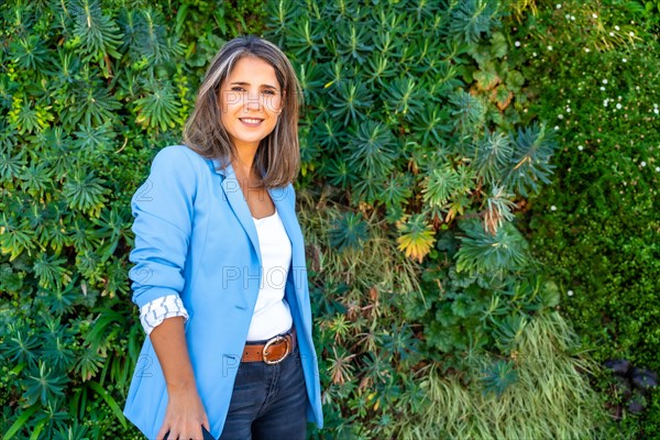 Horizontal portrait with copy space of a mature woman standing outside in a park and smiling