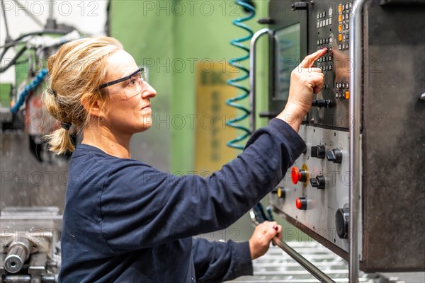 Female factory worker operator working in numerical control sector