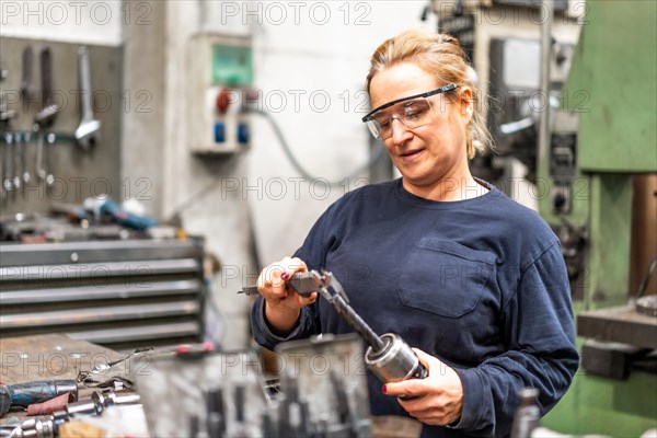 Female factory worker operator working in numerical control sector