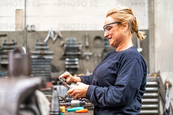 Female factory worker operator working in numerical control sector