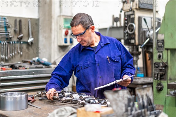 Factory worker operator in the numerical control sector making a report
