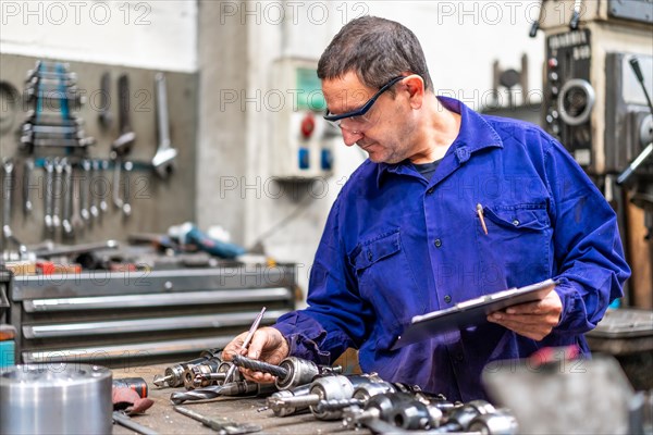 Factory worker operator of the numerical control sector measuring the drill bits