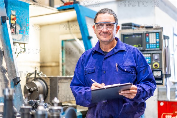 Portrait of factory worker operator in the numerical control sector