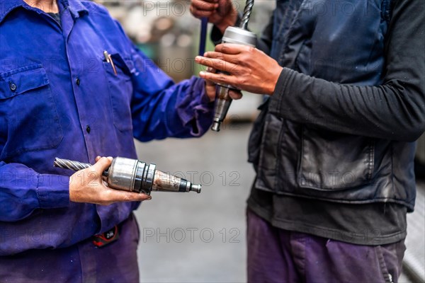 Unrecognizable operators with numerical control metal industrial factory machine tools