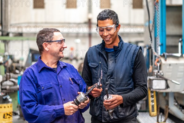 Workers from the metal industrial factory trade in the numerical control sector talking