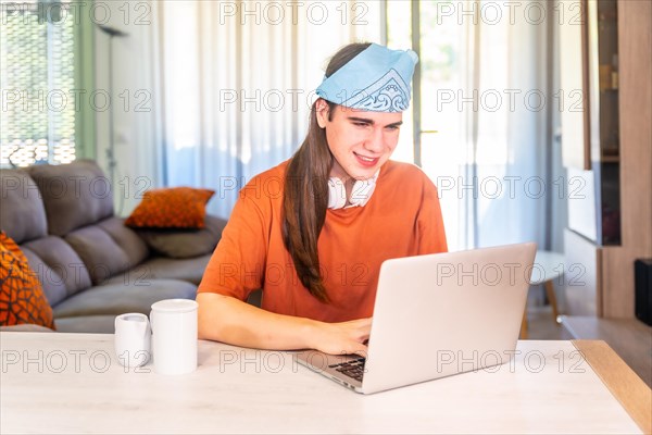 Transgender person working on remote using laptop at home