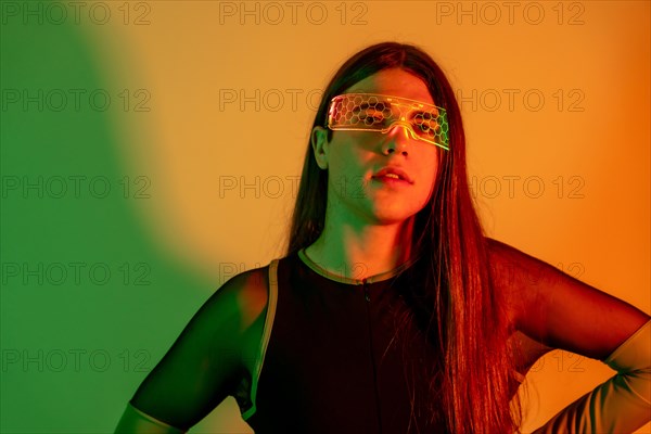 Studio portrait with neon lights of a metaverse transgender person in futuristic neon space