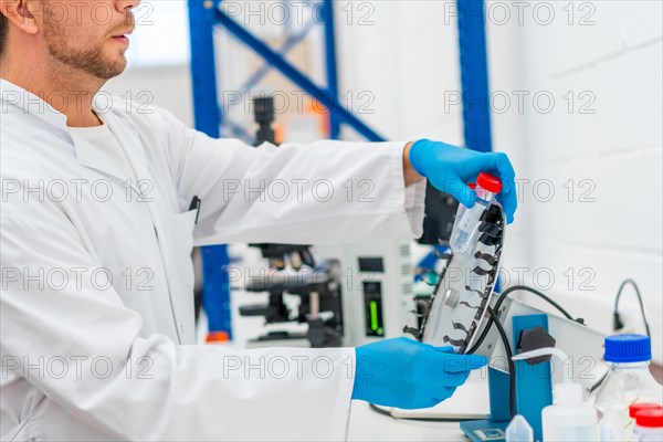 Cropped photo of the side view of a scientist working on cancer cure research in an innovative laboratory