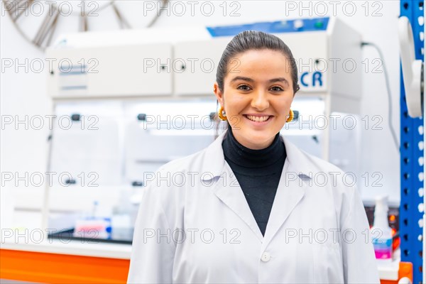 Portrait of a young scientist standing smiling in a laboratory