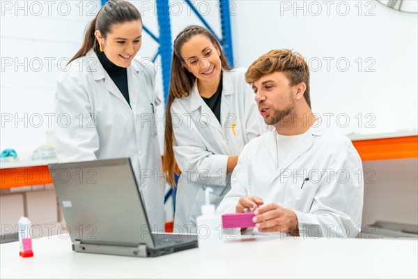 Scientist team using laptop to analysis data of a research study