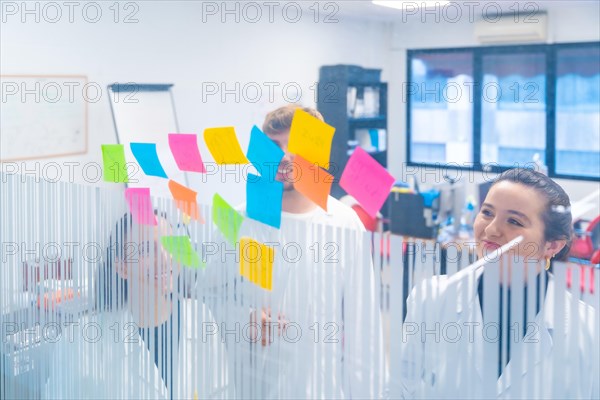 View through the glass of scientist during a brainstorming meeting in a laboratory