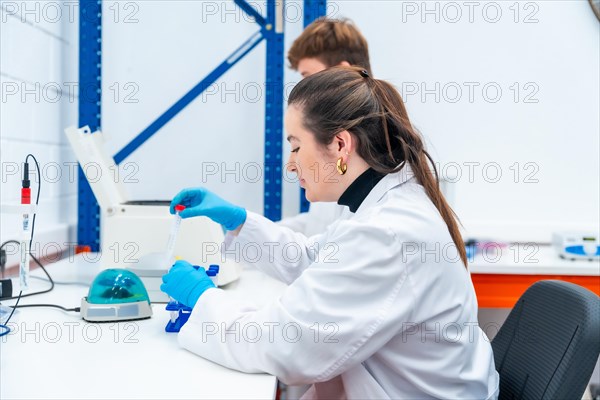 Young scientists working with samples sitting on a research laboratory
