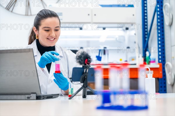 Young female biologist recording a video showing samples in a research laboratory