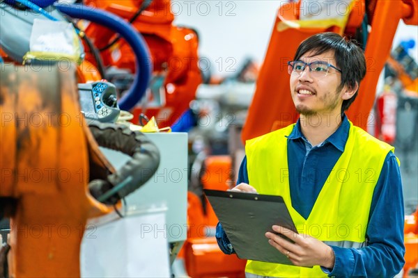 Side view of a proud japanese engineer in an industrial robot industry