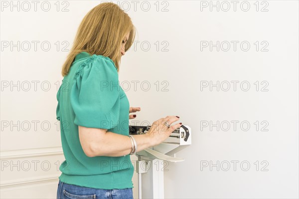 Woman on weighing scale in nutritionist's office. Copy space