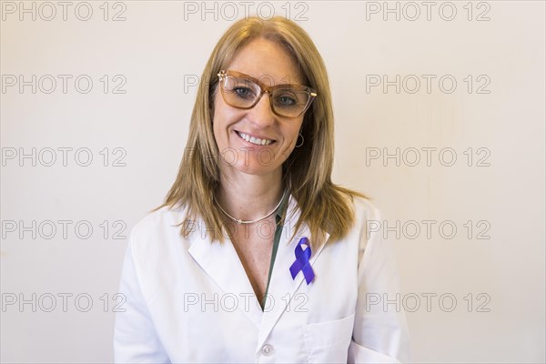 Female doctor using breast cancer awareness ribbon
