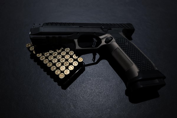 Modern Elegant Handgun and Bullet on Grey Background in Switzerland