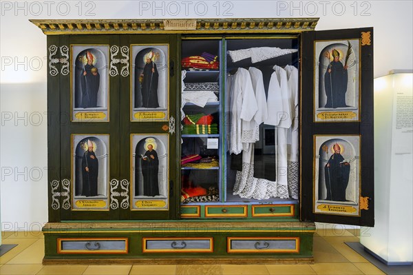 Cupboard with altar cloths and painted pictures of saints in the museum of the monastery