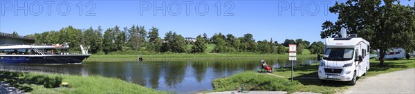 Panoramic photo with a motorhome in the motorhome parking area