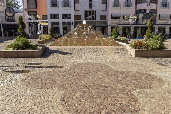 Waterfall of fountain in the form of a stepped pyramid on the square Pl. de la Mairie