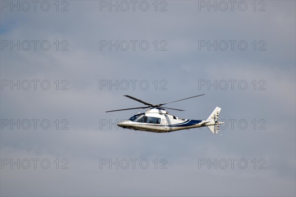 An Agusta A109C helicopter in flight over Buenos Aires