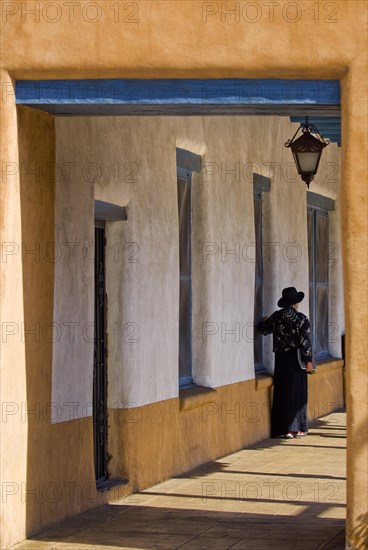 Woman with hat in an arcade in the city centre of Santa Fe