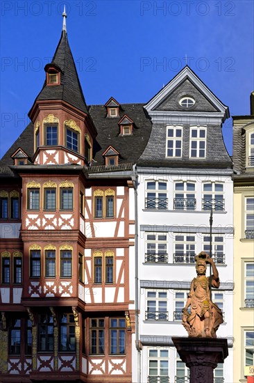 Fountain representing roman goddess Minerva in front of colorful Half-timbered houses in Roemerberg square