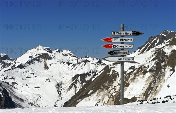 Signpost on the snow-covered Mont Chery summit