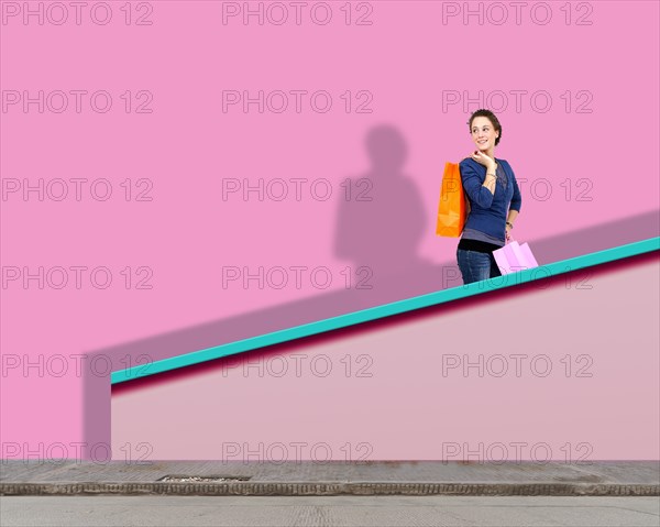 Woman goes up a flight of stairs with her shopping