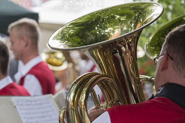 Musician with tuba and sheet of music plays for dancing