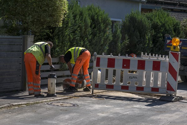 Construction workers flexing a road