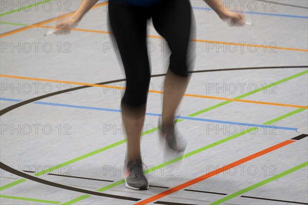 Woman rope skipping in a gymnasium