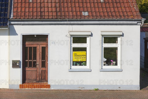 Old house with sign for sale