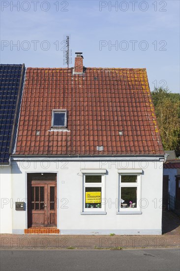 Old house with sign for sale