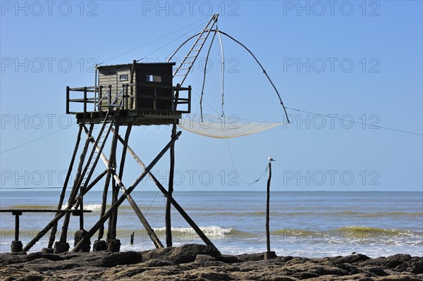 Traditional carrelet fishing hut with lift net on the beach at Saint-Michel-Chef-Chef