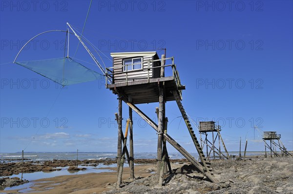 Traditional carrelet fishing huts with lift nets on the beach at Saint-Michel-Chef-Chef