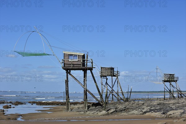 Traditional carrelet fishing huts with lift nets on the beach at Saint-Michel-Chef-Chef